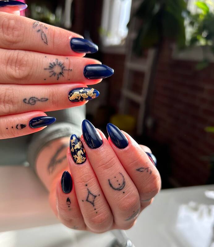 Set of dark blue nails with gold foil done by Yeva at Salon Society